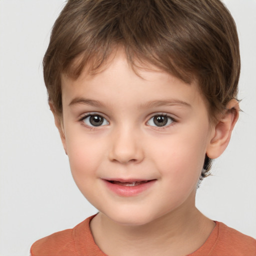 Joyful white child male with short  brown hair and brown eyes