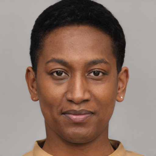 Joyful black young-adult female with short  black hair and brown eyes
