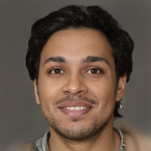 Joyful black young-adult male with short  brown hair and brown eyes