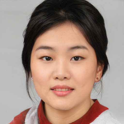 Joyful asian young-adult female with medium  black hair and brown eyes