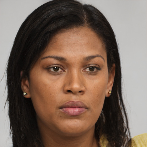 Joyful black young-adult female with long  brown hair and brown eyes