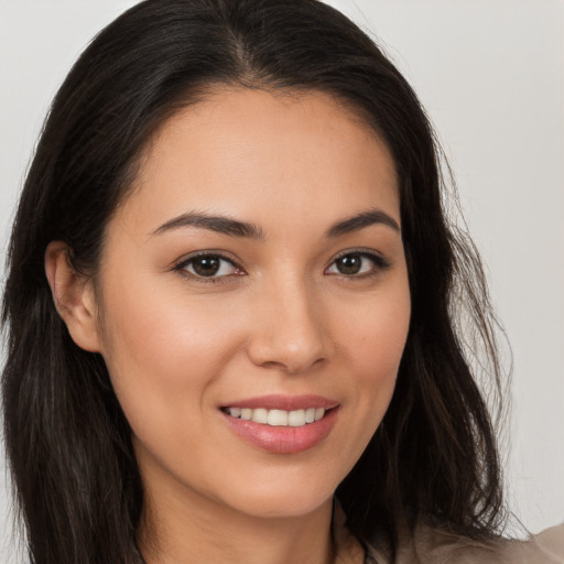 Joyful white young-adult female with long  brown hair and brown eyes