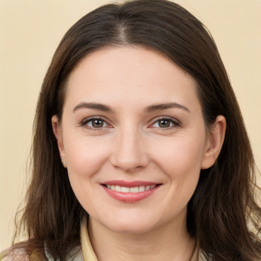 Joyful white young-adult female with long  brown hair and brown eyes