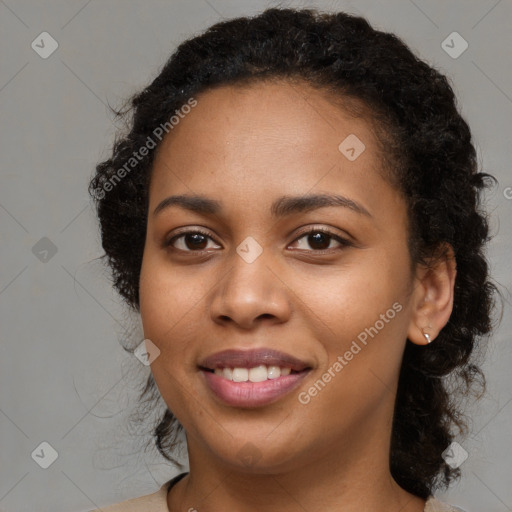 Joyful black young-adult female with medium  brown hair and brown eyes