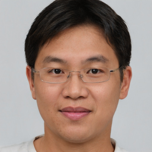 Joyful asian adult male with short  brown hair and brown eyes