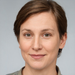 Joyful white adult female with short  brown hair and grey eyes