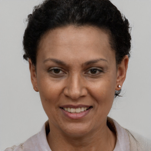 Joyful latino adult female with short  brown hair and brown eyes