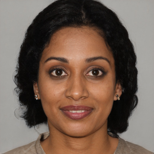 Joyful black young-adult female with medium  black hair and brown eyes
