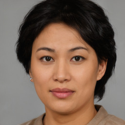 Joyful asian adult female with short  brown hair and brown eyes