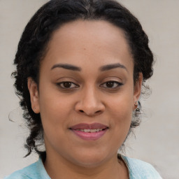 Joyful black young-adult female with medium  brown hair and brown eyes