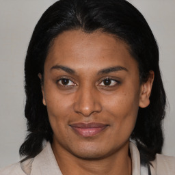 Joyful asian adult female with medium  brown hair and brown eyes