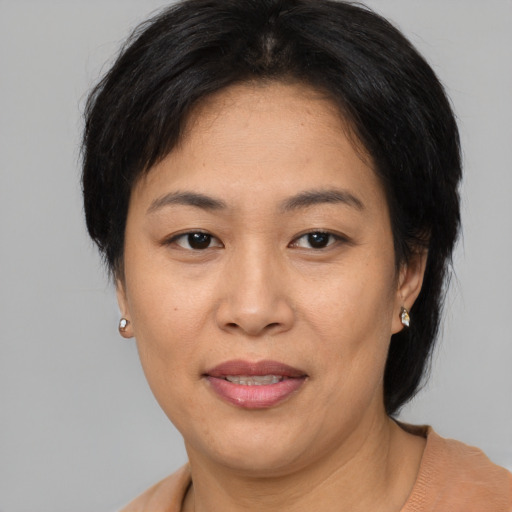 Joyful asian adult female with short  brown hair and brown eyes