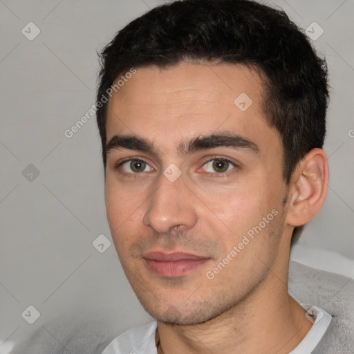 Joyful white young-adult male with short  black hair and brown eyes