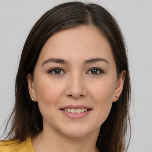 Joyful white young-adult female with long  brown hair and brown eyes