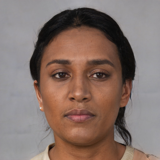 Neutral asian adult female with short  black hair and brown eyes