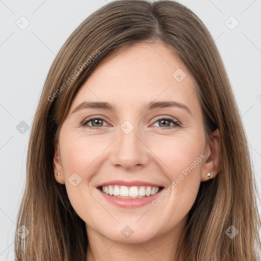 Joyful white young-adult female with long  brown hair and grey eyes