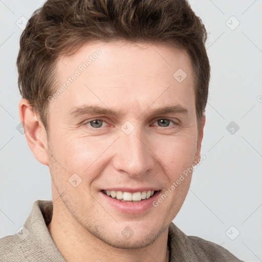 Joyful white adult male with short  brown hair and grey eyes