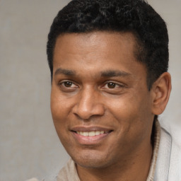 Joyful latino young-adult male with short  black hair and brown eyes