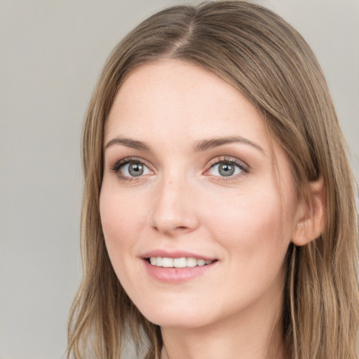 Joyful white young-adult female with long  brown hair and grey eyes