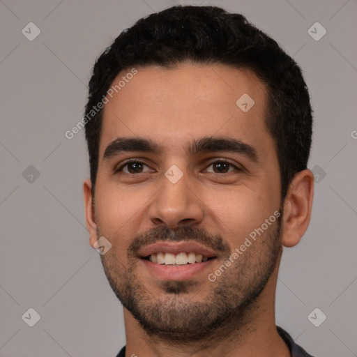 Joyful white young-adult male with short  black hair and brown eyes