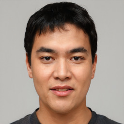 Joyful asian young-adult male with short  black hair and brown eyes