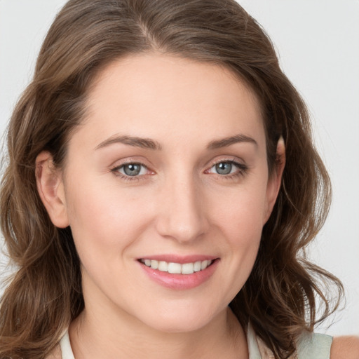 Joyful white young-adult female with medium  brown hair and blue eyes