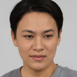 Joyful asian adult female with short  black hair and brown eyes