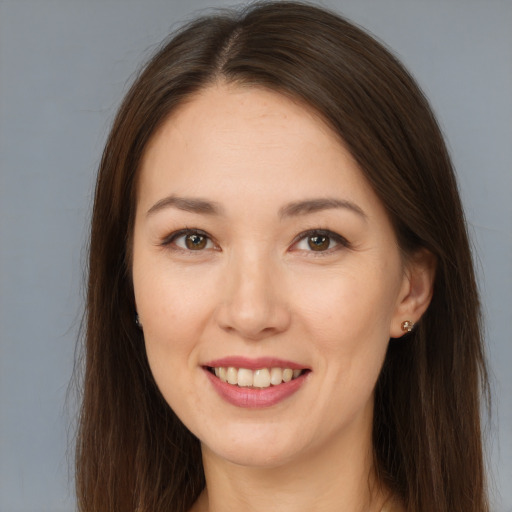 Joyful white young-adult female with long  brown hair and brown eyes