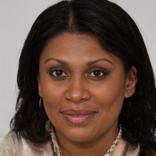 Joyful black adult female with medium  brown hair and brown eyes