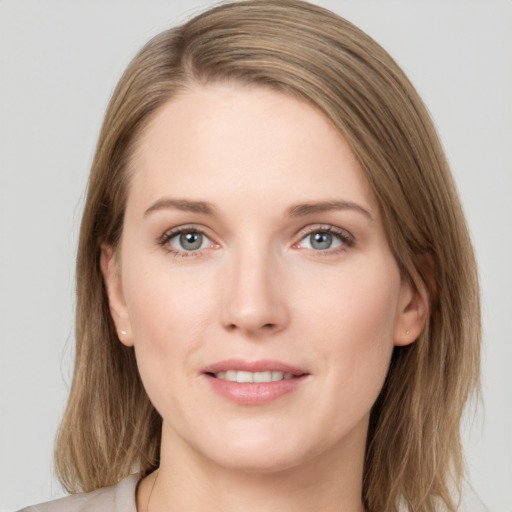 Joyful white young-adult female with long  brown hair and grey eyes