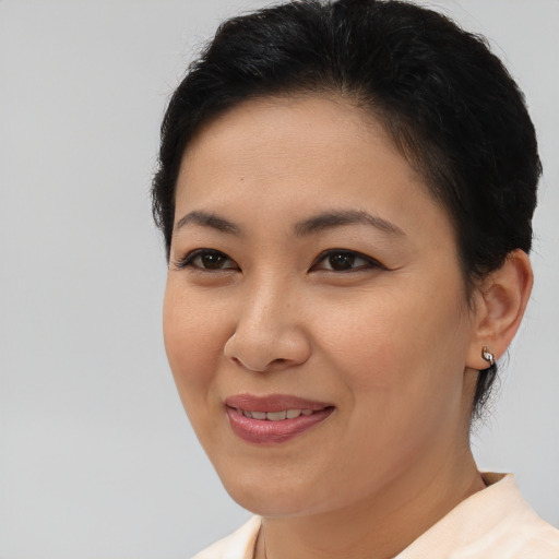 Joyful asian young-adult female with short  brown hair and brown eyes