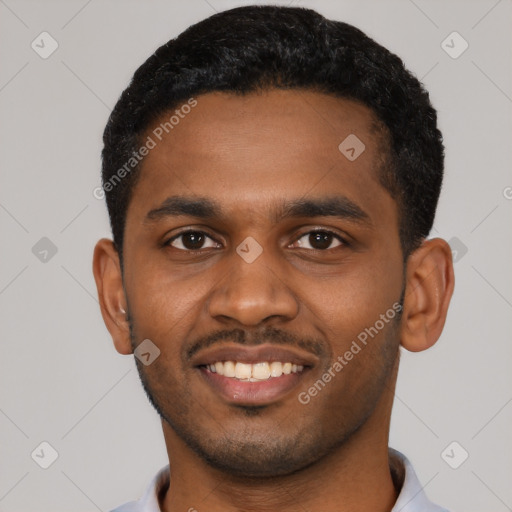 Joyful black young-adult male with short  black hair and brown eyes