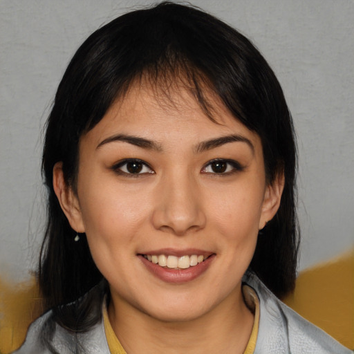Joyful white young-adult female with medium  black hair and brown eyes