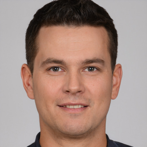 Joyful white young-adult male with short  brown hair and brown eyes