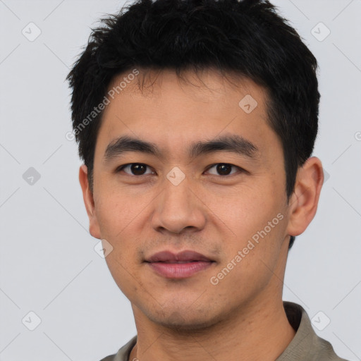 Joyful asian young-adult male with short  black hair and brown eyes