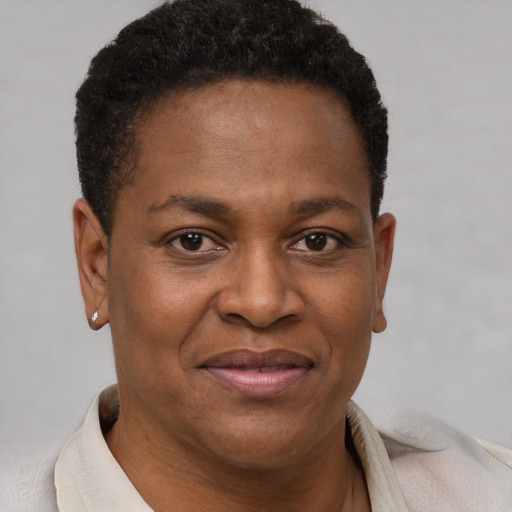Joyful black adult female with short  brown hair and brown eyes