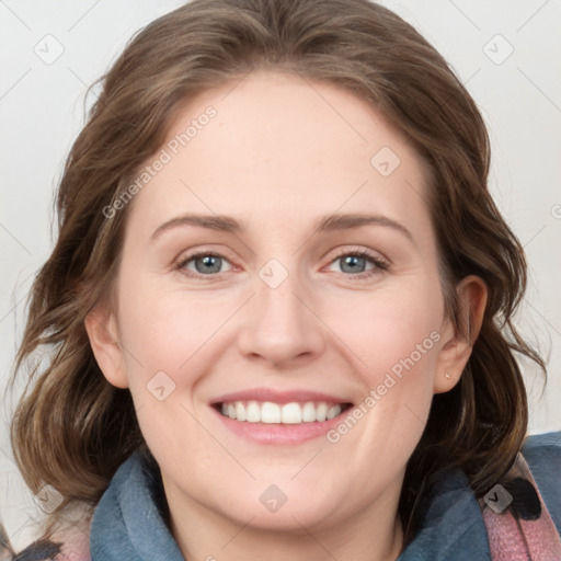 Joyful white young-adult female with medium  brown hair and blue eyes