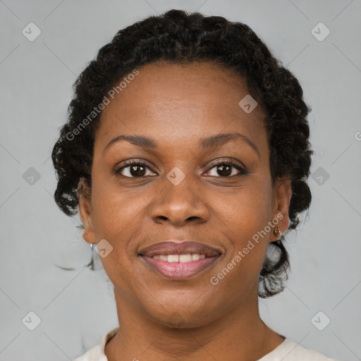 Joyful black adult female with short  brown hair and brown eyes