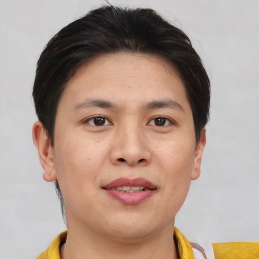 Joyful asian young-adult female with short  brown hair and brown eyes