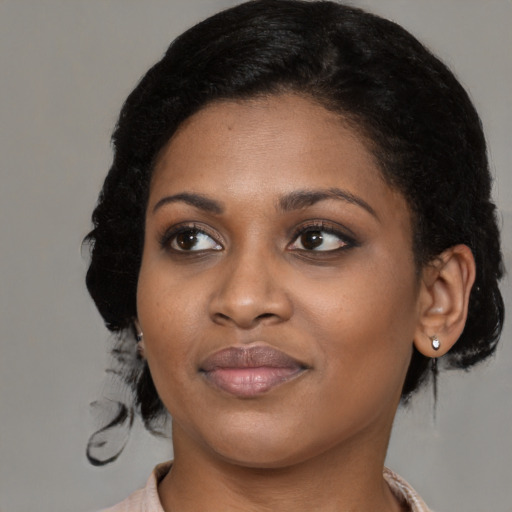 Joyful black young-adult female with medium  black hair and brown eyes
