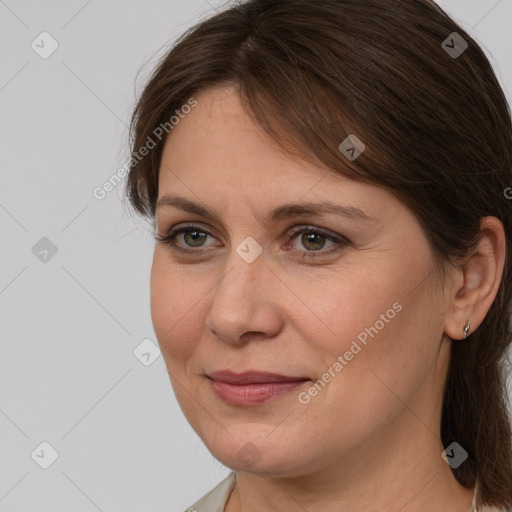 Joyful white adult female with medium  brown hair and grey eyes