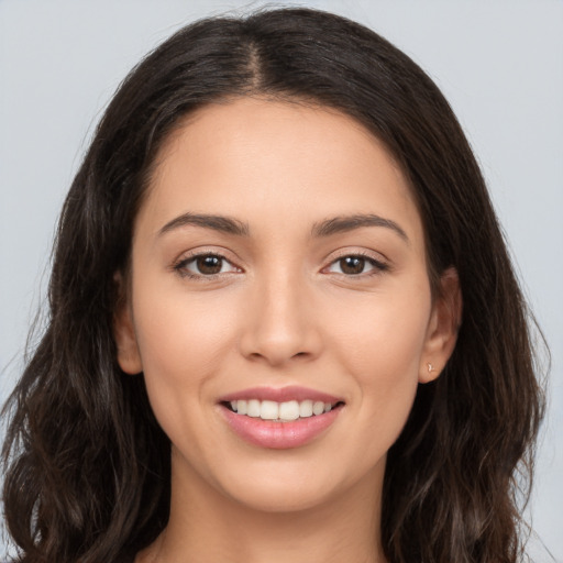 Joyful white young-adult female with long  brown hair and brown eyes