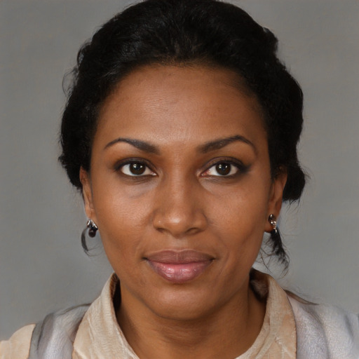 Joyful black adult female with medium  black hair and brown eyes