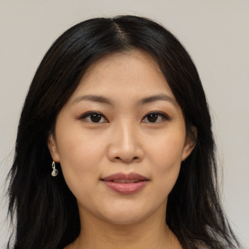 Joyful asian young-adult female with long  black hair and brown eyes