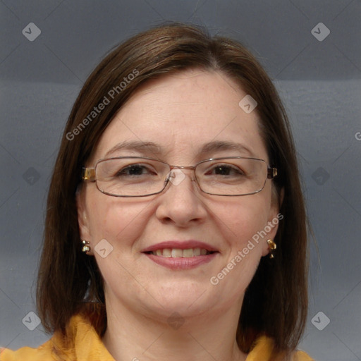 Joyful white adult female with medium  brown hair and blue eyes