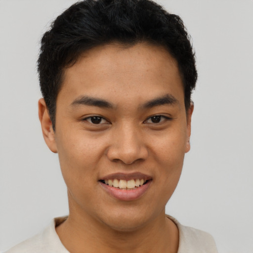 Joyful asian young-adult male with short  black hair and brown eyes