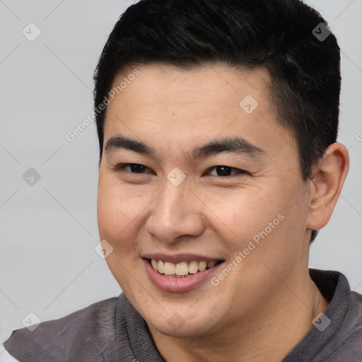 Joyful asian young-adult male with short  brown hair and brown eyes