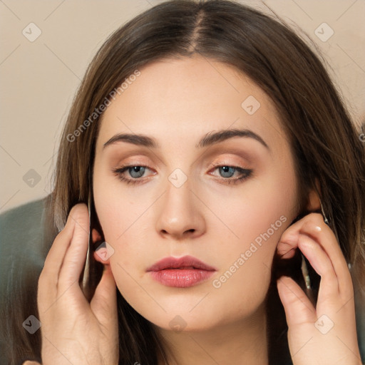 Neutral white young-adult female with long  brown hair and brown eyes