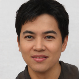 Joyful asian young-adult male with short  black hair and brown eyes