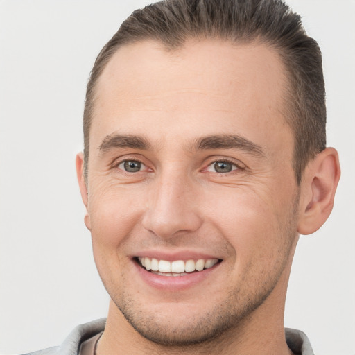 Joyful white young-adult male with short  brown hair and brown eyes